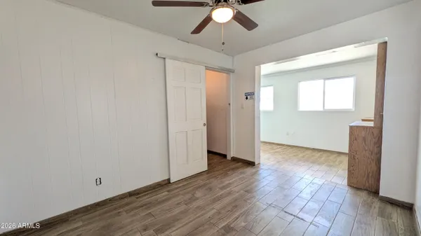 a view of an empty room with wooden floor