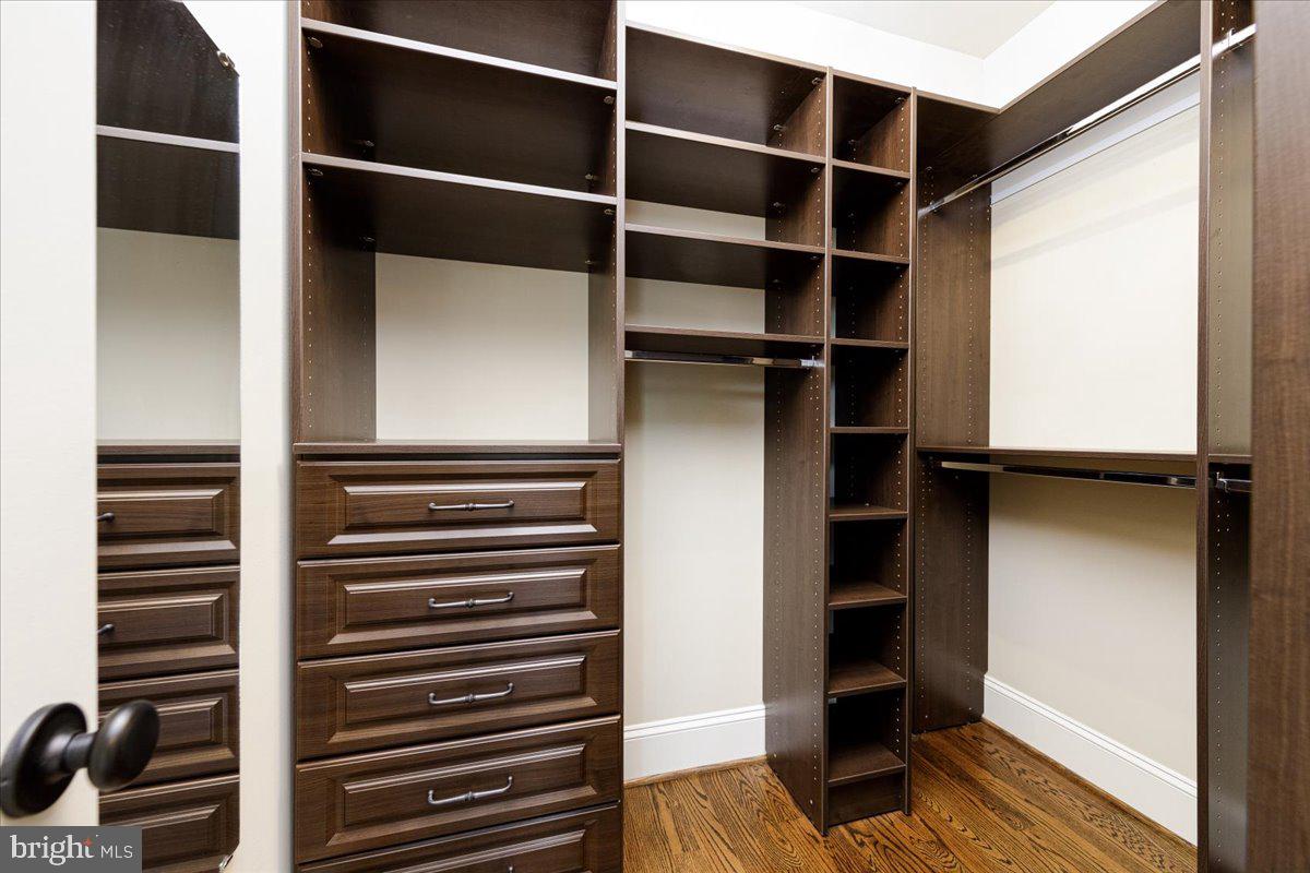 8104 Old Georgetown Road Bethesda, MD 20814 - Photo 14 of 28 a view of walk in closet with clothes and shoes