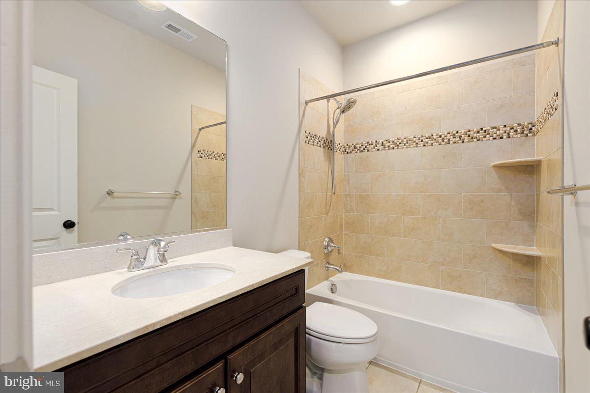 8104 Old Georgetown Road Bethesda, MD 20814 - Photo 18 of 28 a bathroom with a sink a toilet and a bathtub