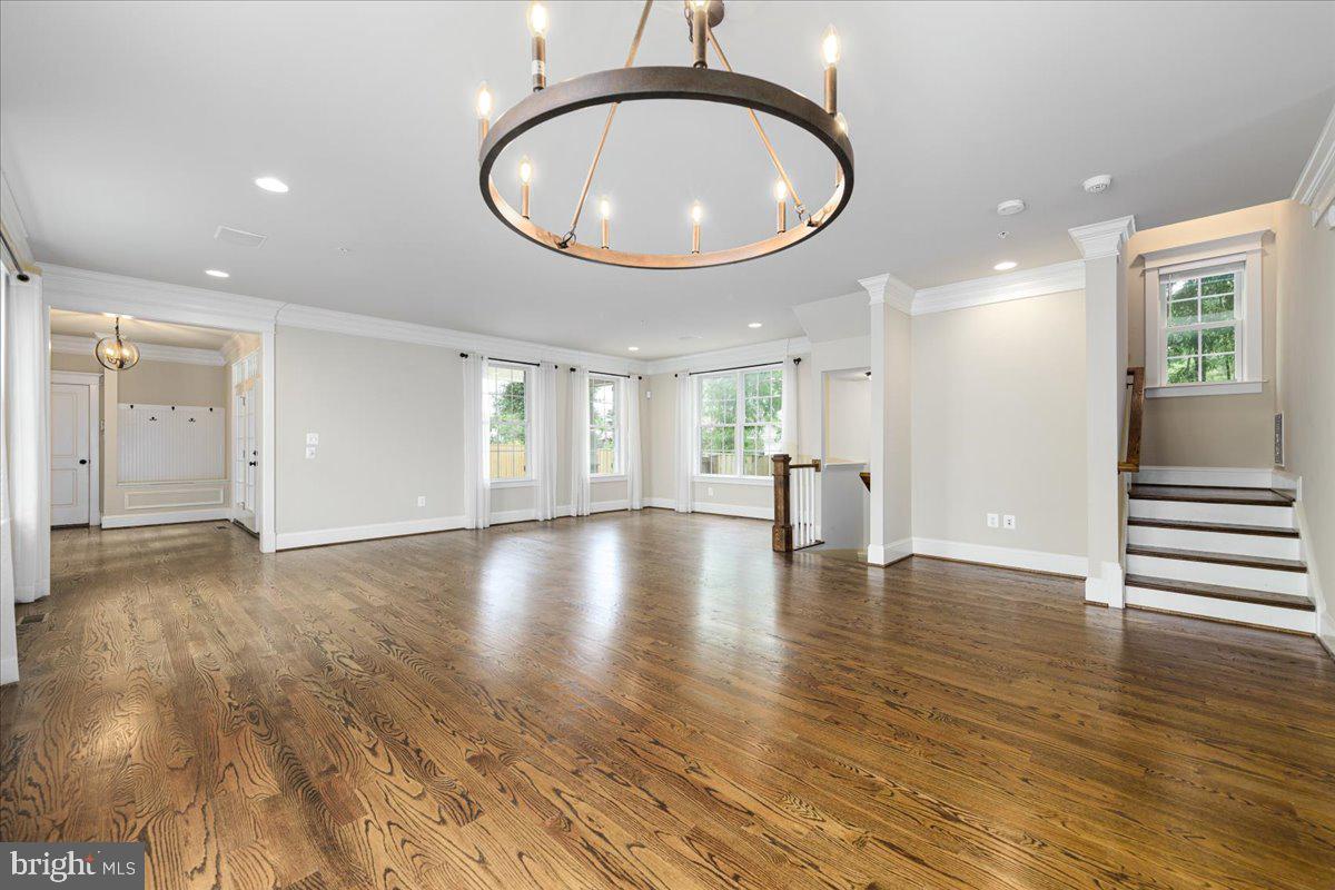 8104 Old Georgetown Road Bethesda, MD 20814 - Photo 6 of 28 a view of an empty room with wooden floor and a mirror
