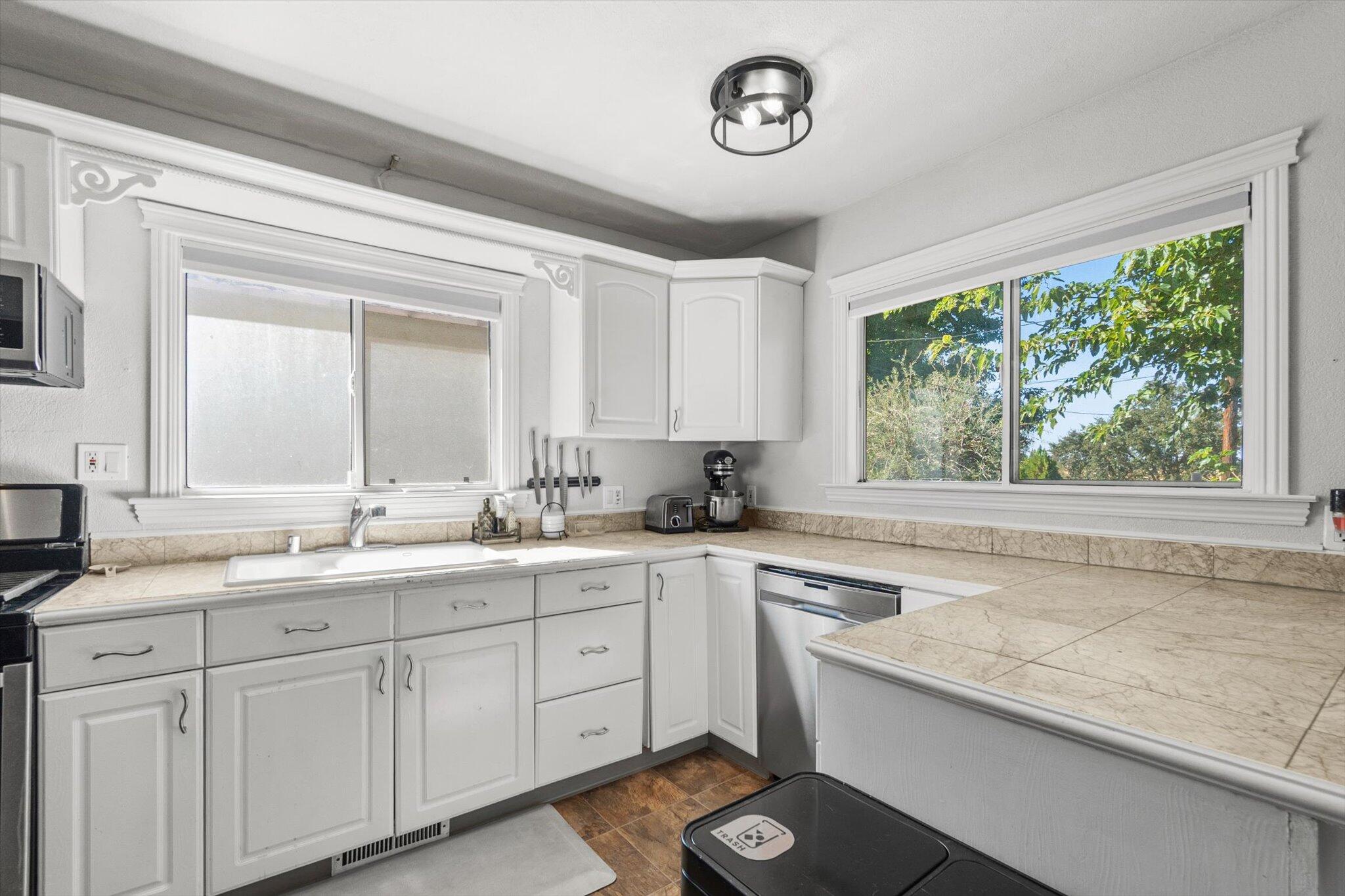 1514 Walbridge Street Red Bluff, CA 96080 - Photo 12 of 36 a kitchen with a sink cabinets and window