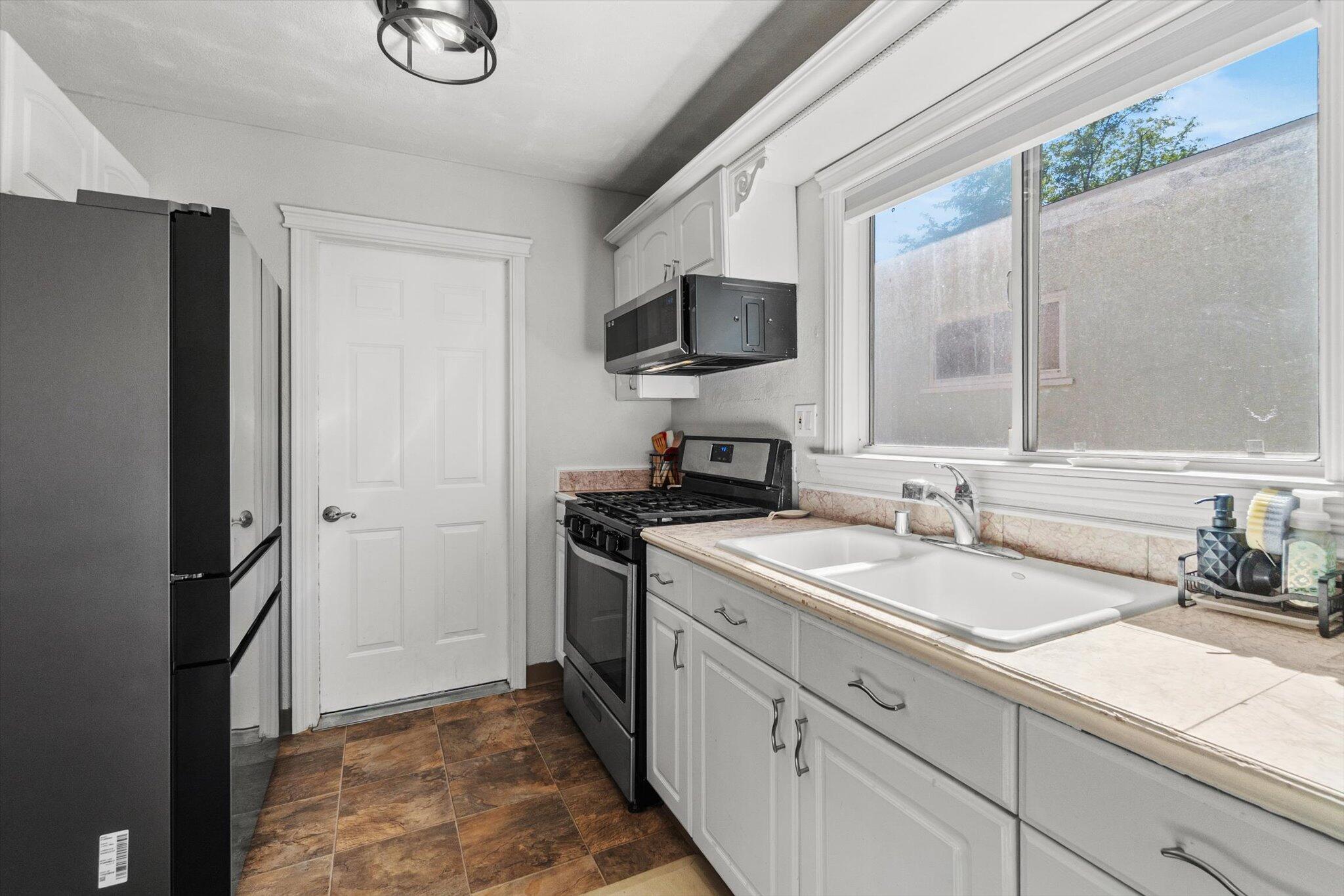 1514 Walbridge Street Red Bluff, CA 96080 - Photo 13 of 36 a kitchen with a sink stove and refrigerator