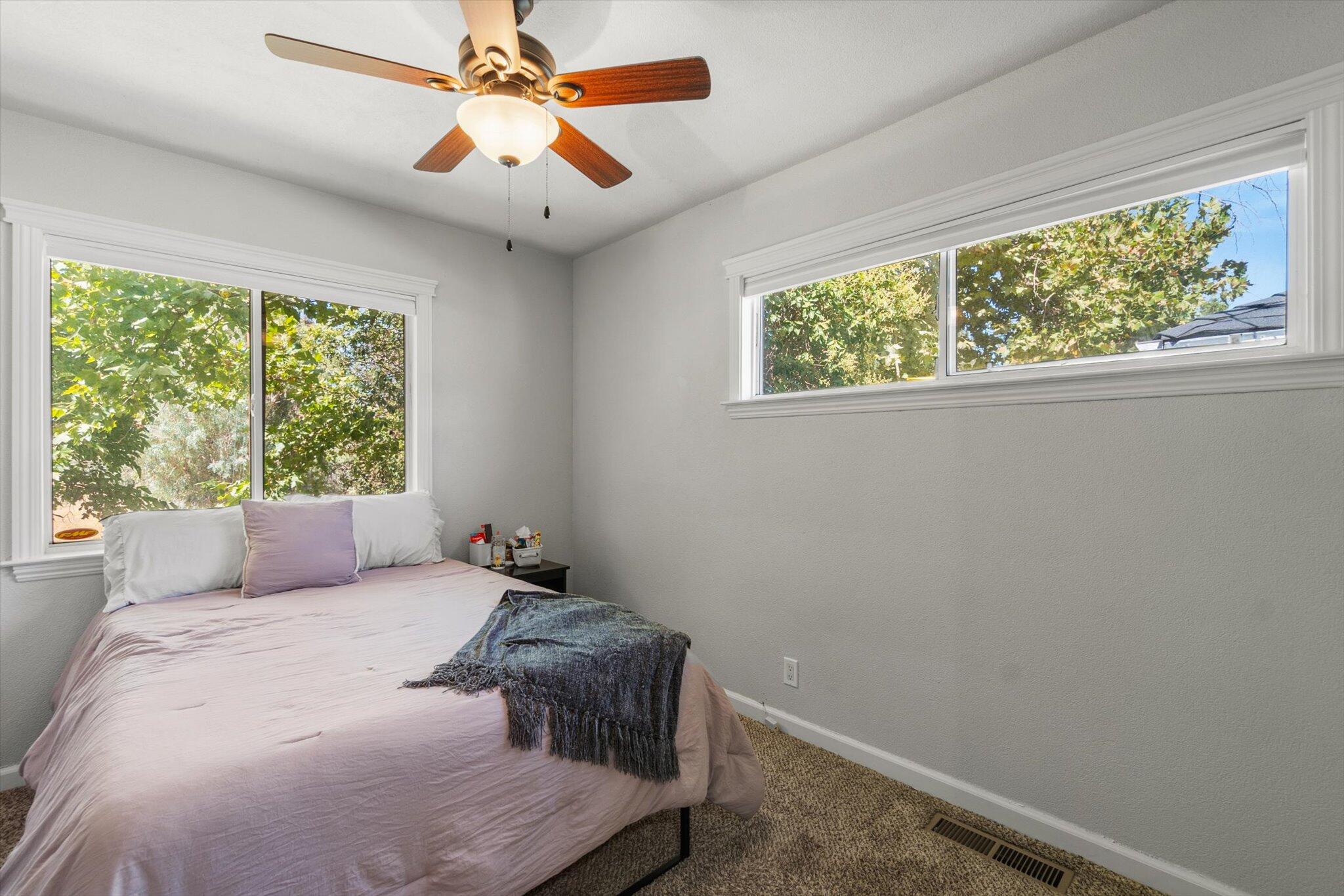 1514 Walbridge Street Red Bluff, CA 96080 - Photo 17 of 36 a bedroom with a large bed and a window