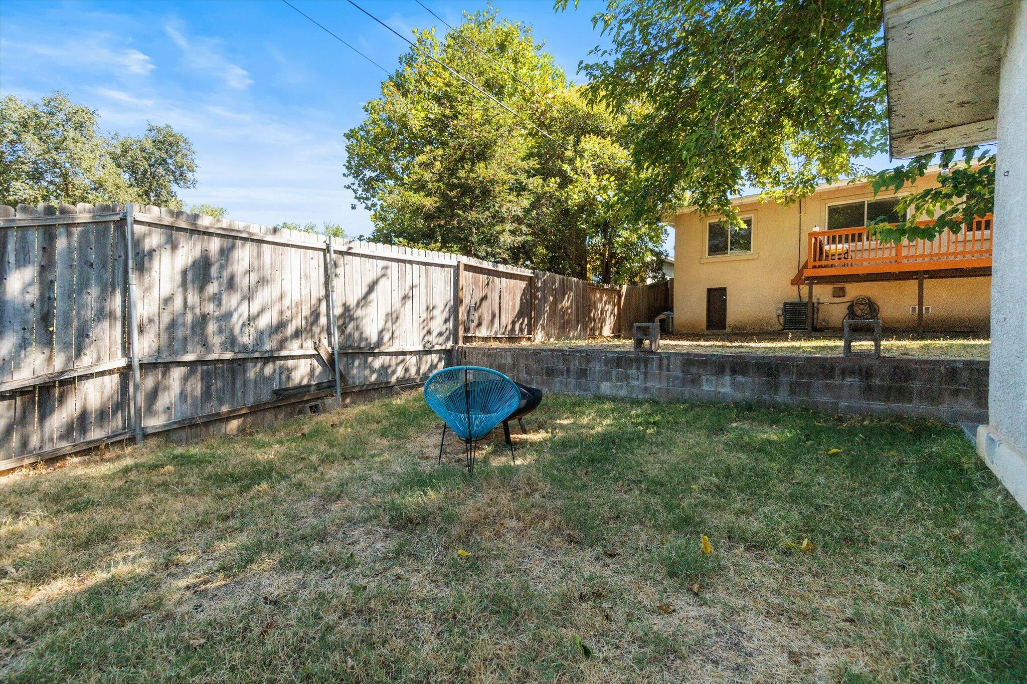 1514 Walbridge Street Red Bluff, CA 96080 - Photo 30 of 36 a view of a backyard with plants and a lake view