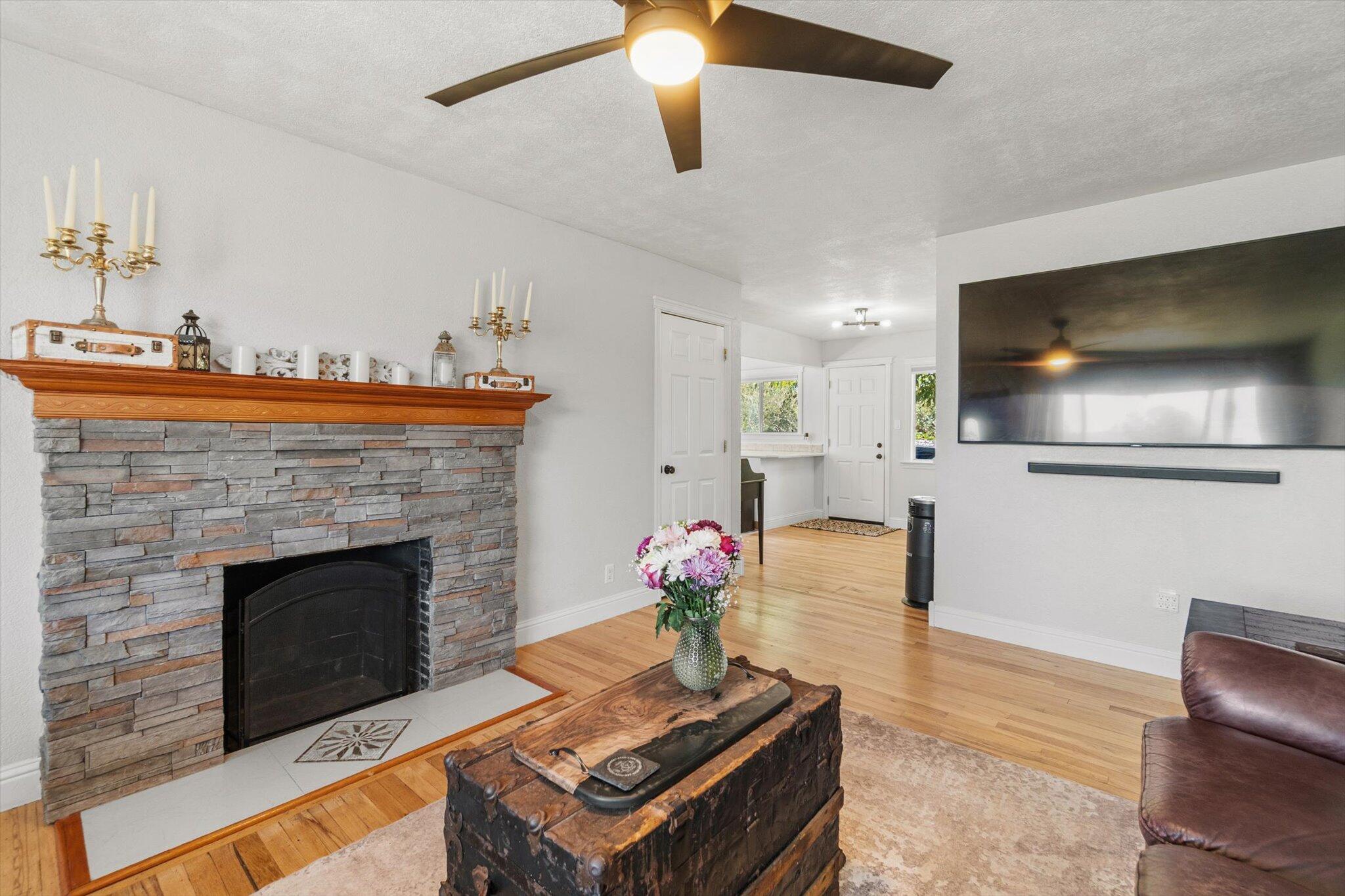 1514 Walbridge Street Red Bluff, CA 96080 - Photo 5 of 36 a living room with furniture a fireplace and a flat screen tv