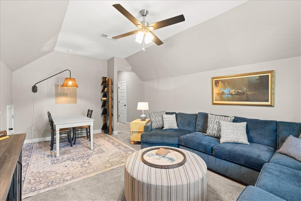 7610 Scenic Overlook Cumming, GA 30041 - Photo 35 of 62 a living room with furniture a rug and a wall painting