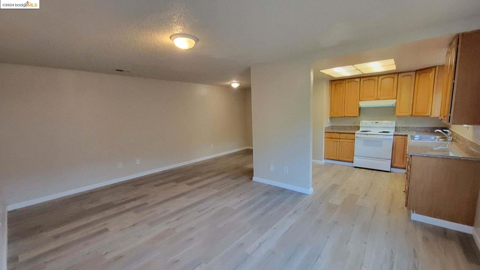 Pittsburg Pittsburg, CA 94565 - Photo 3 of 4 wooden floor in an empty room with a window