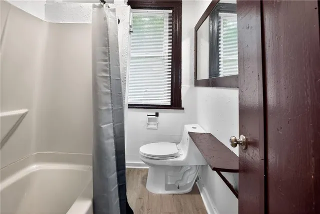 a bathroom with a toilet a sink and bathtub