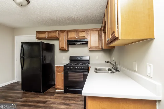 a kitchen with a refrigerator and a sink