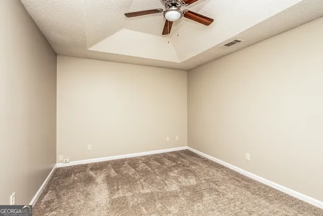 a view of a room with a ceiling fan