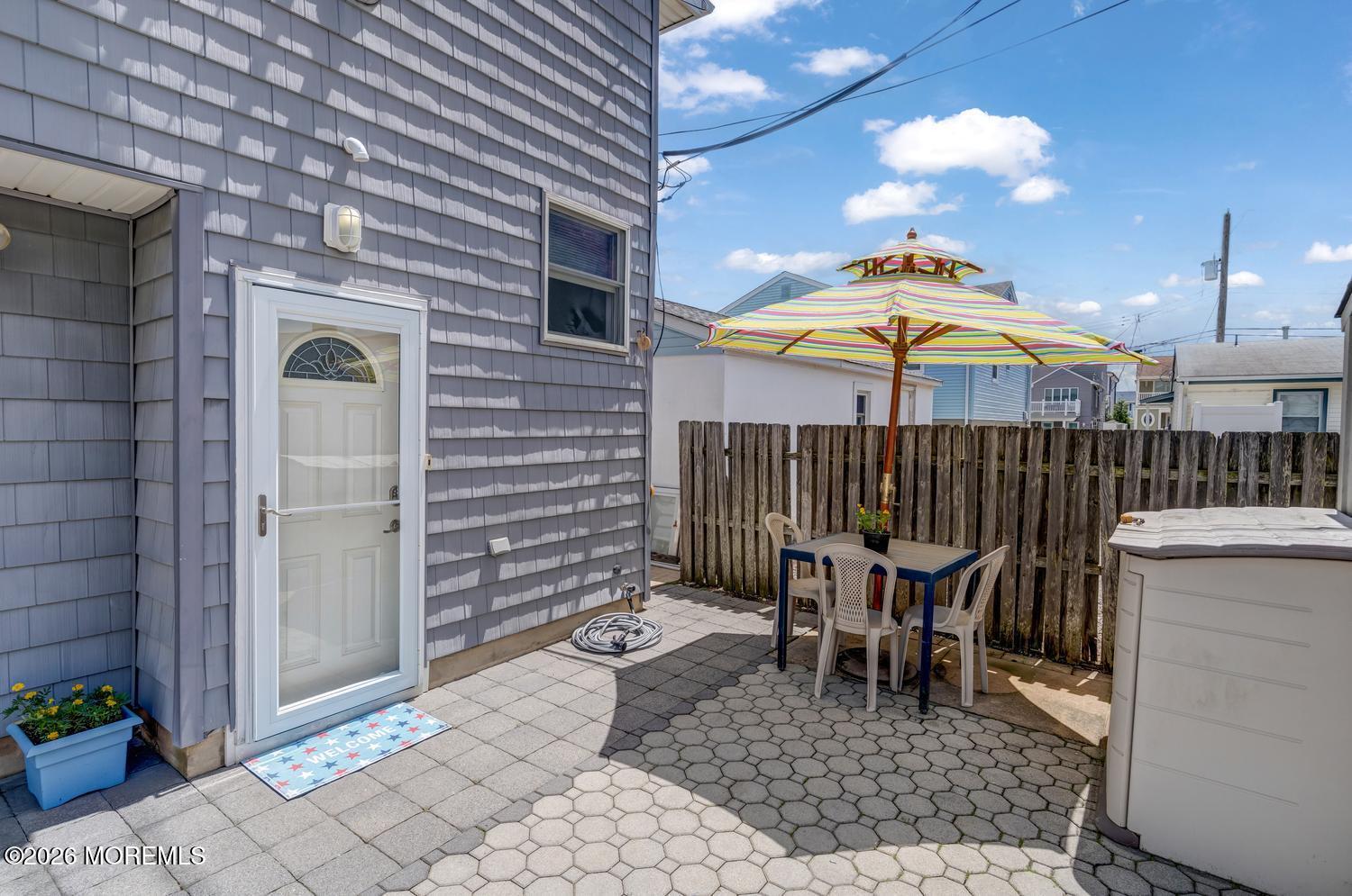 19 Shore Way Lavallette, NJ 08735 - Photo 3 of 38 a view of a patio with a table and chairs under an umbrella
