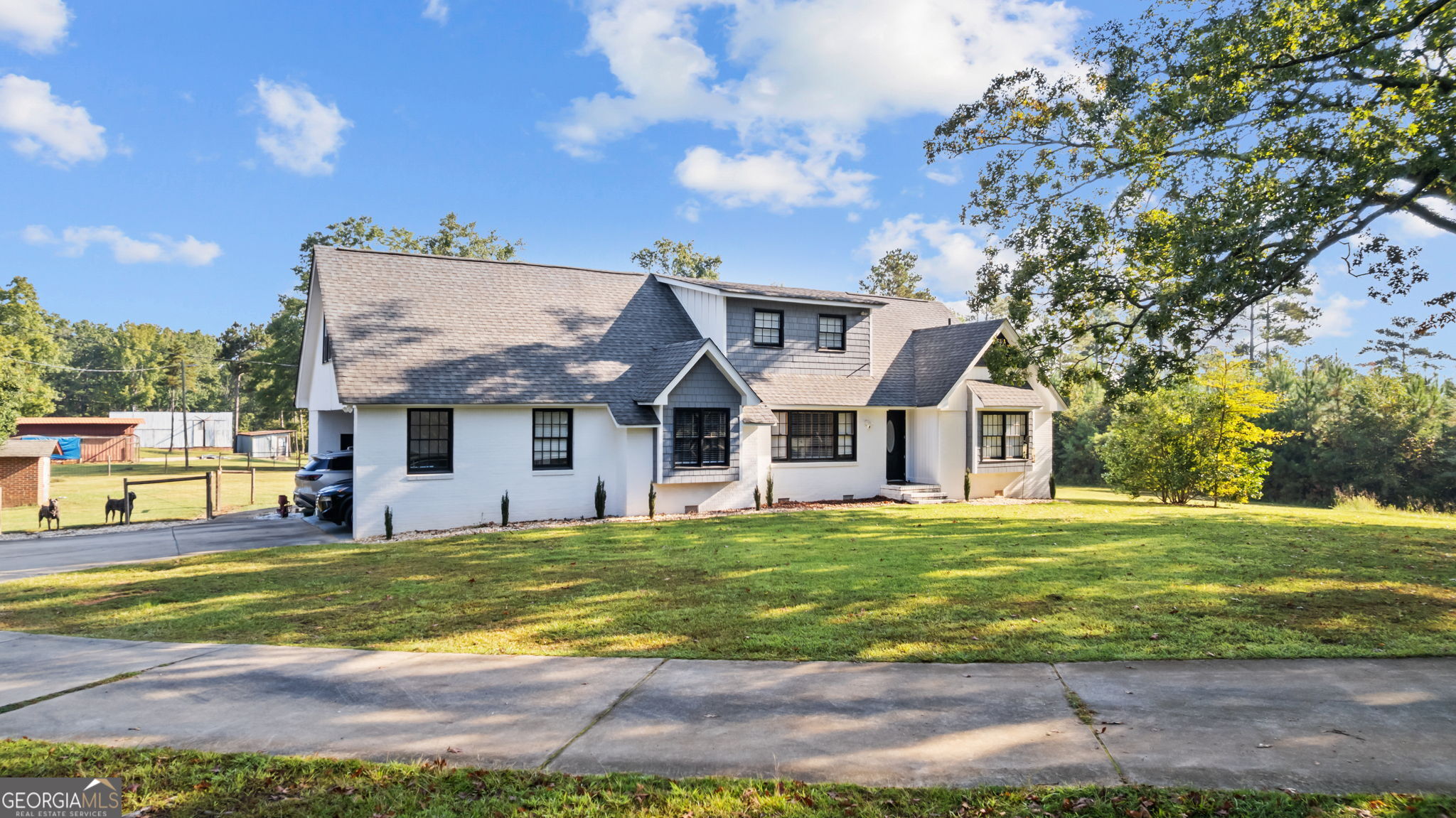 2987 Steele Road Griffin, GA 30223 - Photo 17 of 22 a view of a big house with a big yard and large trees