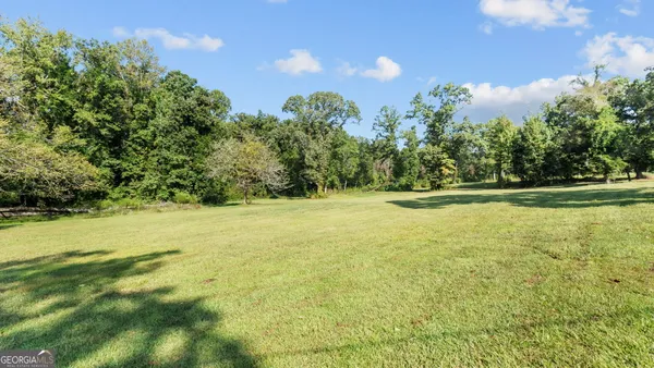 a view of outdoor space with yard and trees around