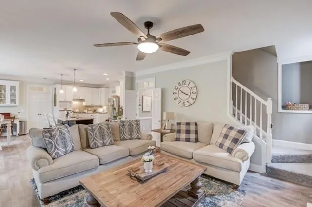 a living room with furniture and a ceiling fan