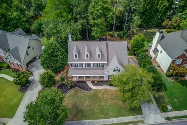 an aerial view of a house with garden space and street view