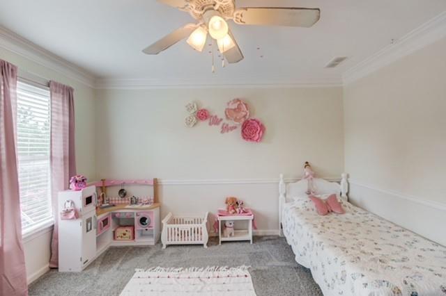 1727 Bakers Mill Road Dacula, GA 30019 - Photo 21 of 39 a bedroom with a bed and a chandelier