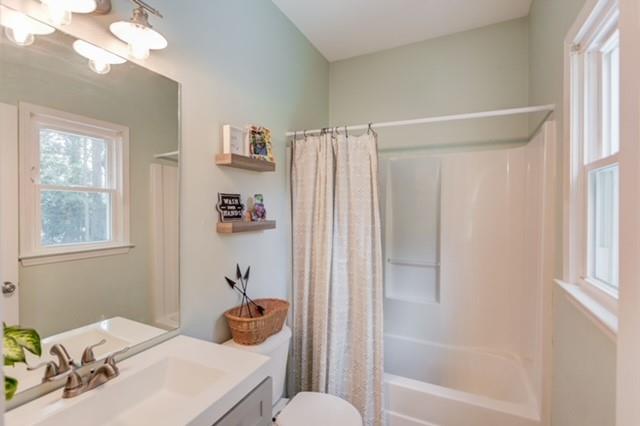1727 Bakers Mill Road Dacula, GA 30019 - Photo 25 of 39 a bathroom with a sink a toilet and shower