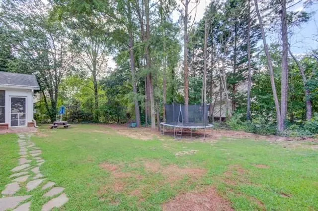 a view of a backyard with a swing