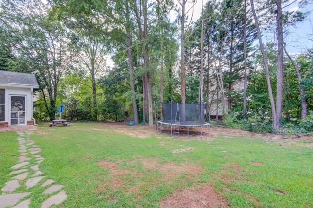 1727 Bakers Mill Road Dacula, GA 30019 - Photo 30 of 39 a view of a backyard with large trees