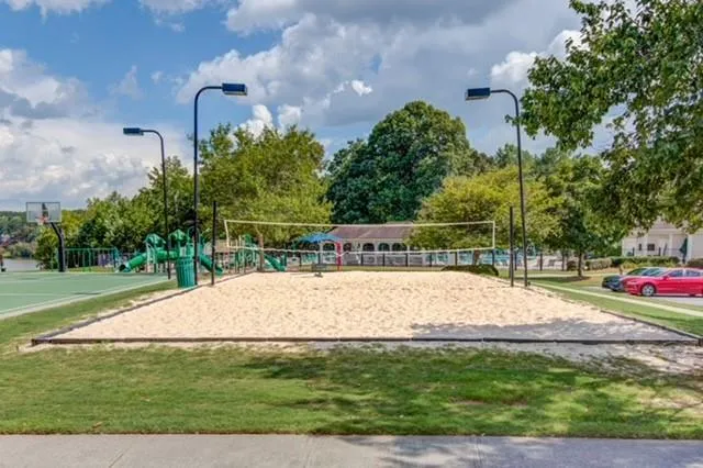 a swimming pool with lots of tress in the background