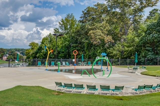 1727 Bakers Mill Road Dacula, GA 30019 - Photo 34 of 39 a swimming pool with lots of tress in the background