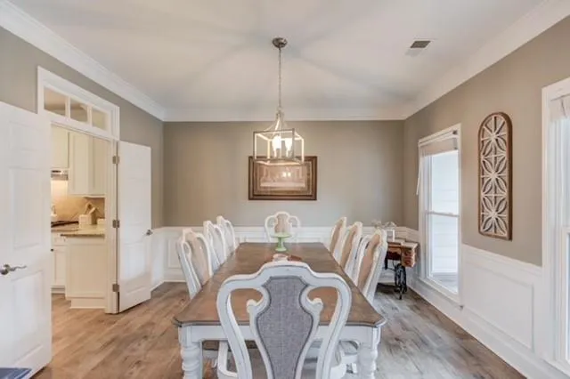 a view of a dining room with furniture window and wooden floor
