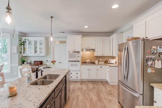 1727 Bakers Mill Road Dacula, GA 30019 - Photo 9 of 39 a kitchen with stainless steel appliances granite countertop a sink refrigerator and cabinets