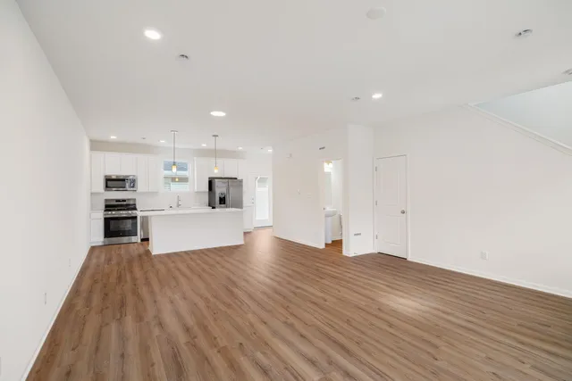 a view of a kitchen with cabinets and wooden floor