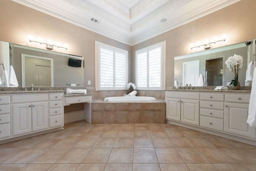 165 Autry Trail Alpharetta, GA 30022 - Photo 27 of 70 a spacious bathroom with a granite countertop sink a mirror a bathtub and window