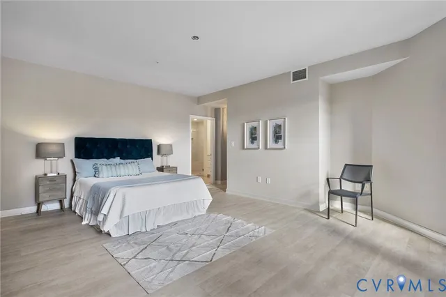 a bedroom with a bed and a chair