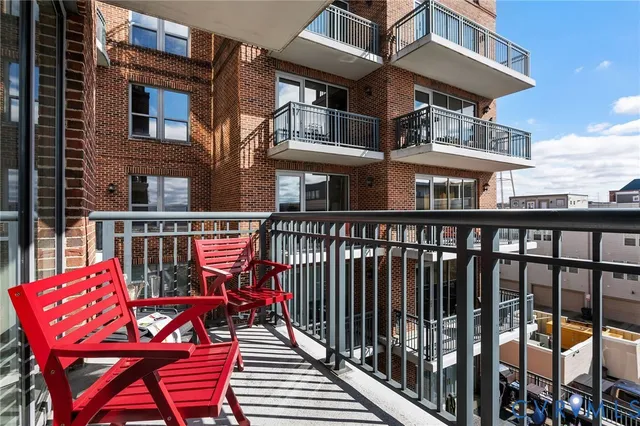 a view of a balcony with chairs