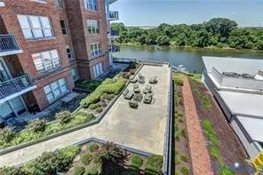 an aerial view of a house with outdoor space and lake view