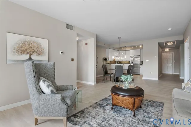 a living room with furniture and wooden floor