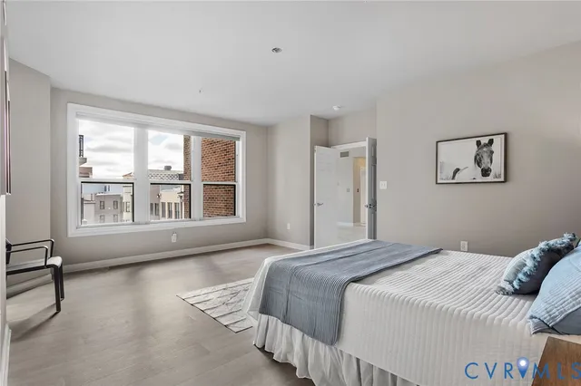 a bedroom with bed and a large window