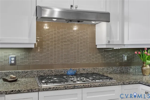 a kitchen with granite countertop cabinets