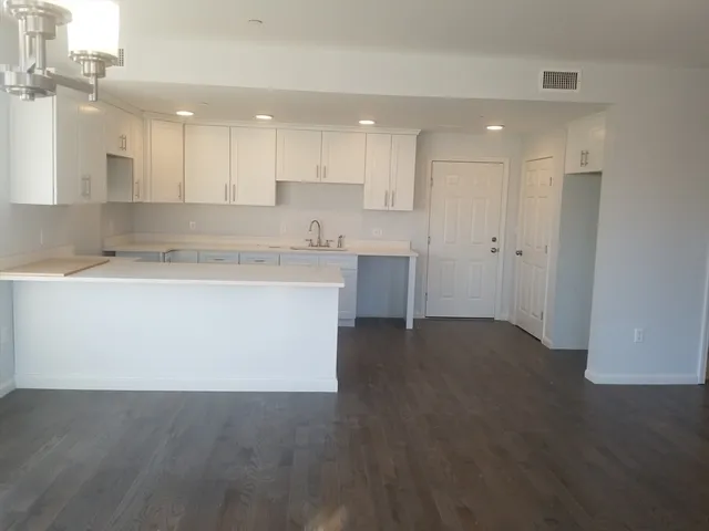 a view of kitchen with kitchen island sink and refrigerator