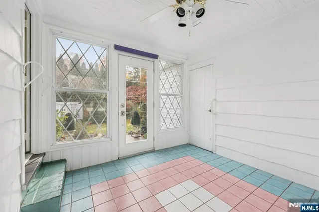 a view of a room with a window and a potted plant