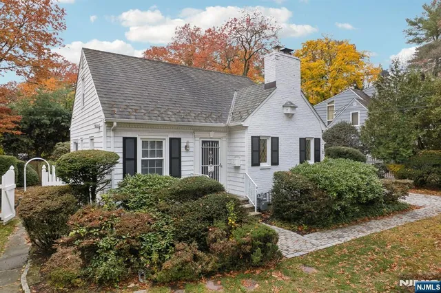 a front view of house with yard and trees around