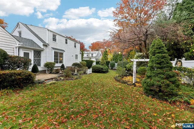 an aerial view of a house with yard and sitting area