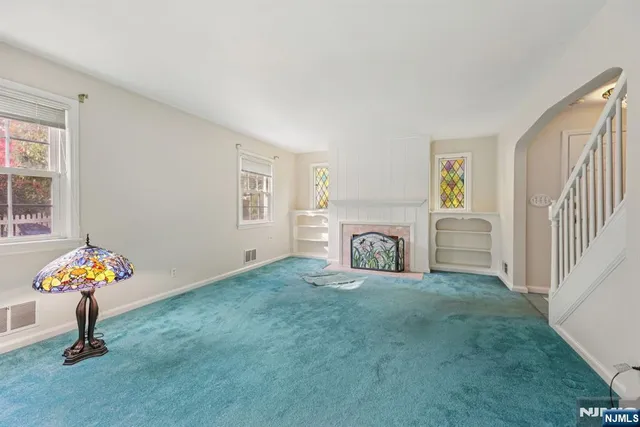 a living room with furniture and a fireplace