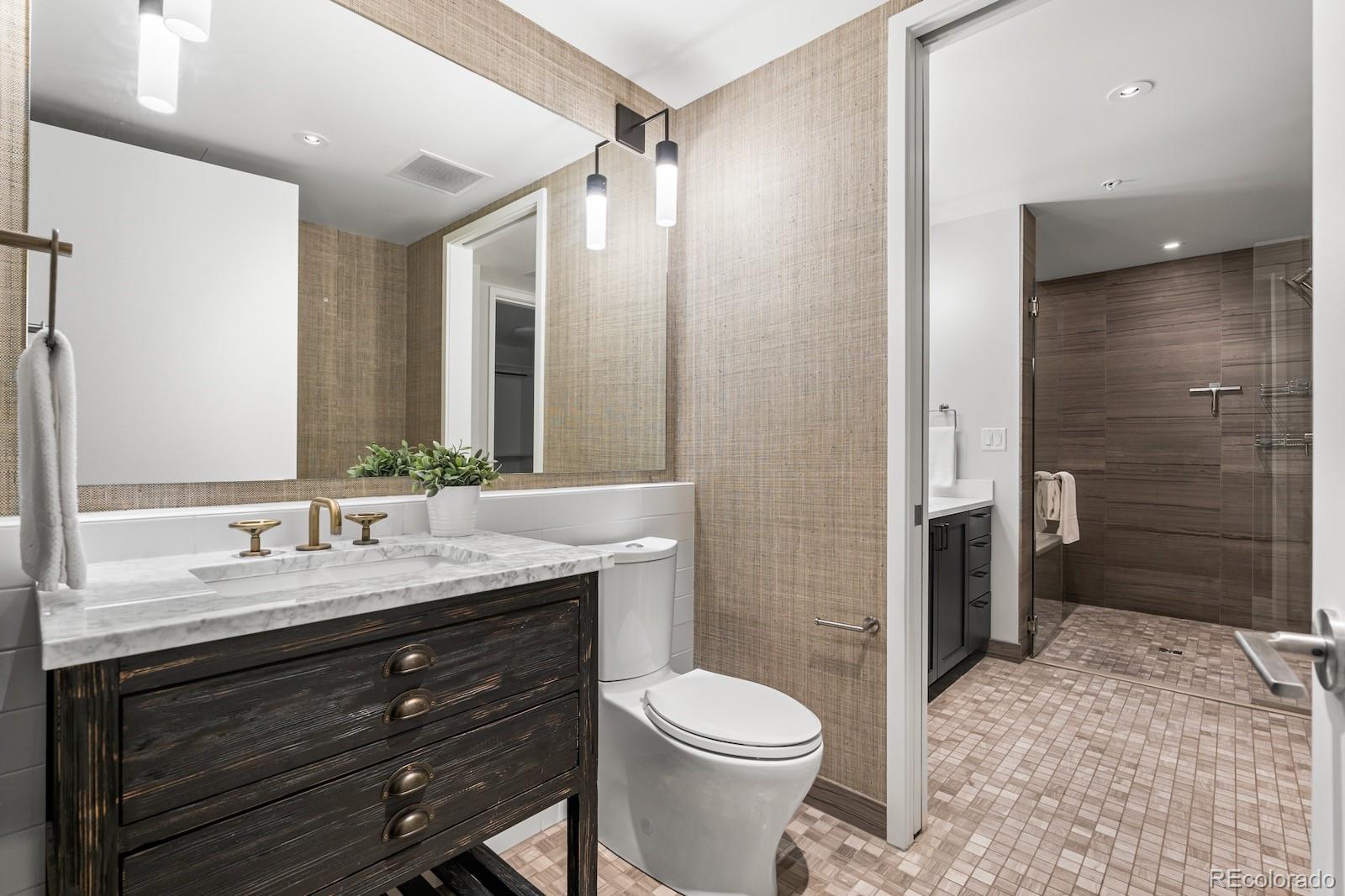 1750 Wewatta Street, Unit 1030 Denver, CO 80202 - Photo 12 of 50 a bathroom with a sink a toilet and shower