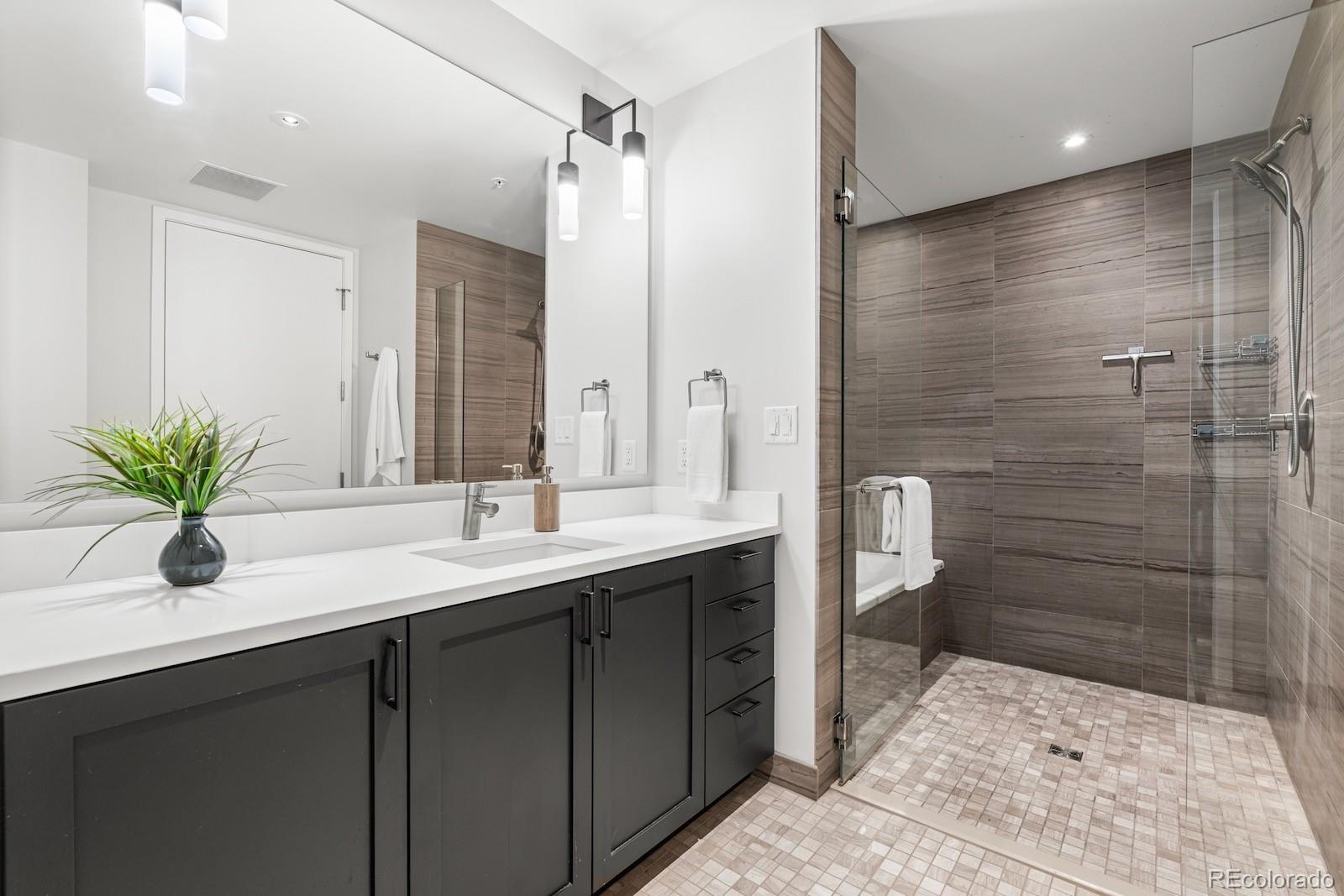 1750 Wewatta Street, Unit 1030 Denver, CO 80202 - Photo 13 of 50 a bathroom with a double vanity sink and mirror