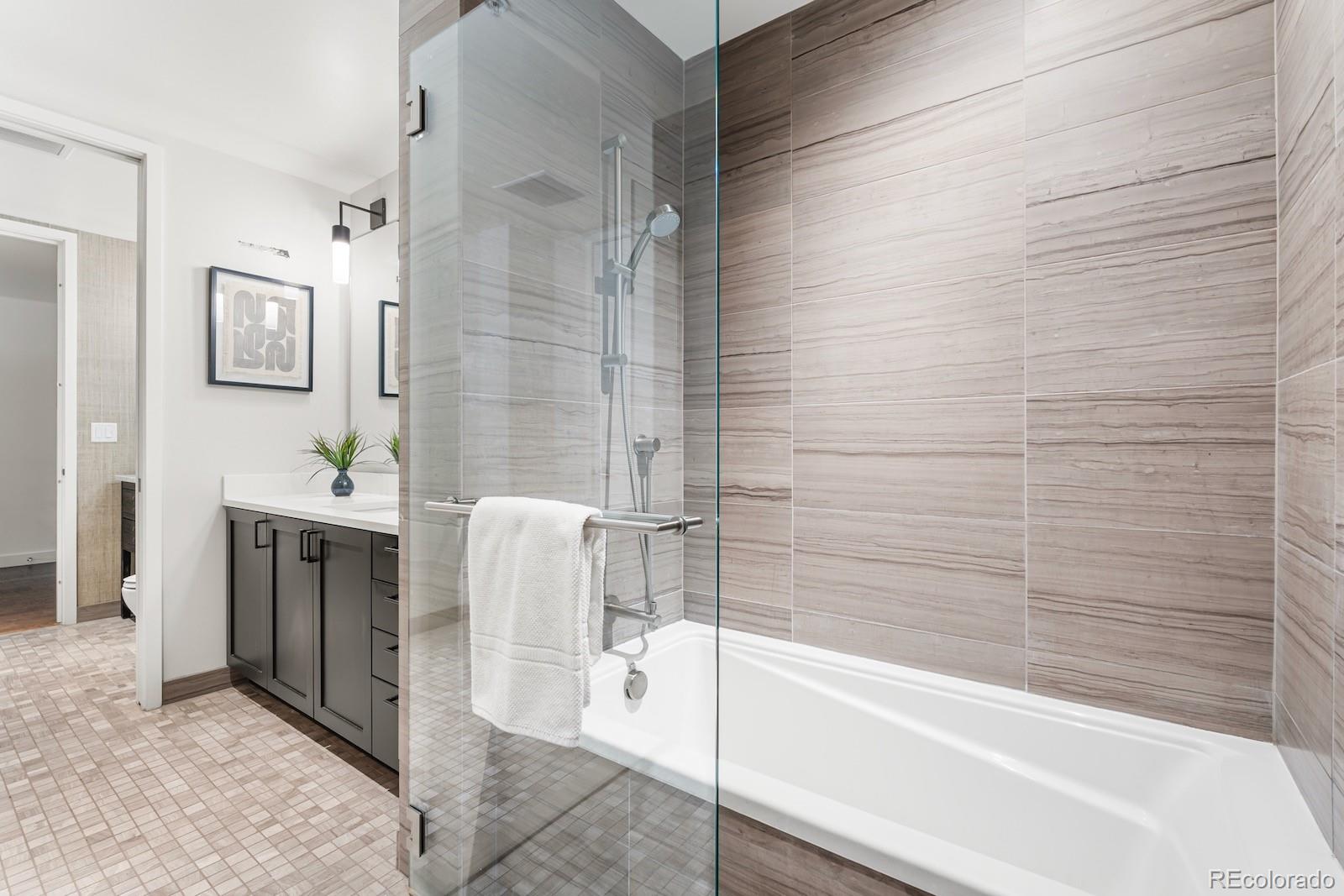 1750 Wewatta Street, Unit 1030 Denver, CO 80202 - Photo 15 of 50 a bathroom with a bathtub and a sink