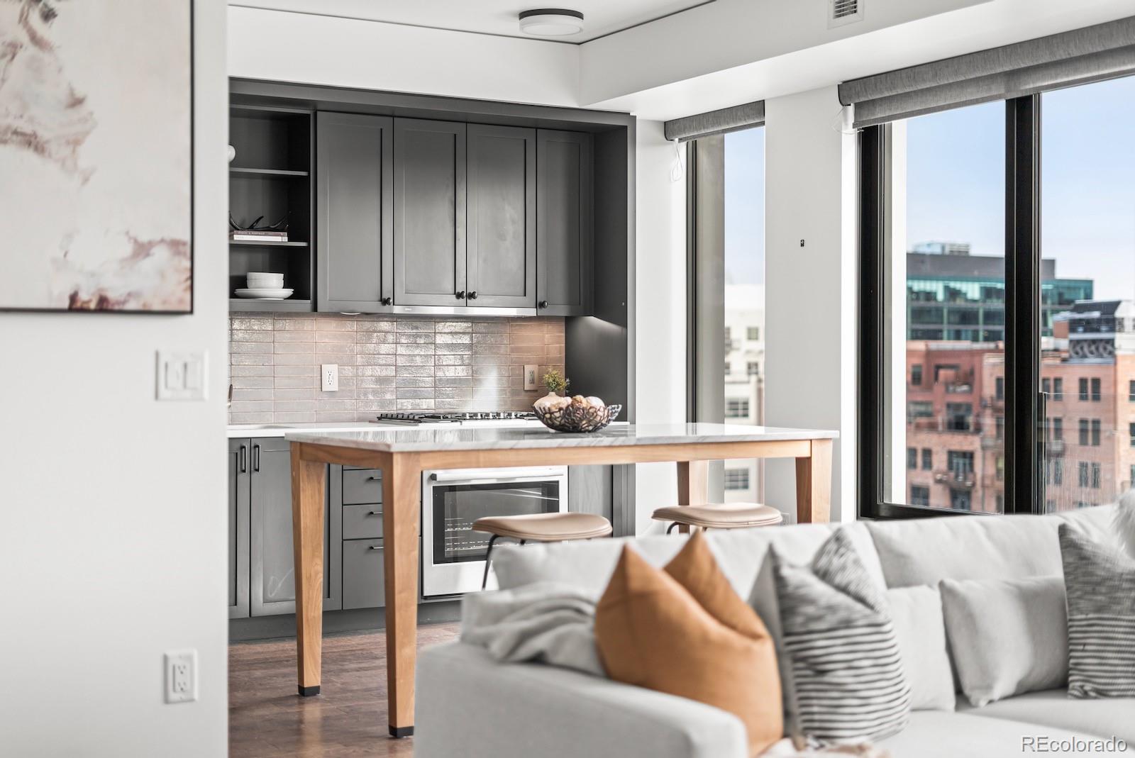 1750 Wewatta Street, Unit 1030 Denver, CO 80202 - Photo 16 of 50 a living room with furniture and large window