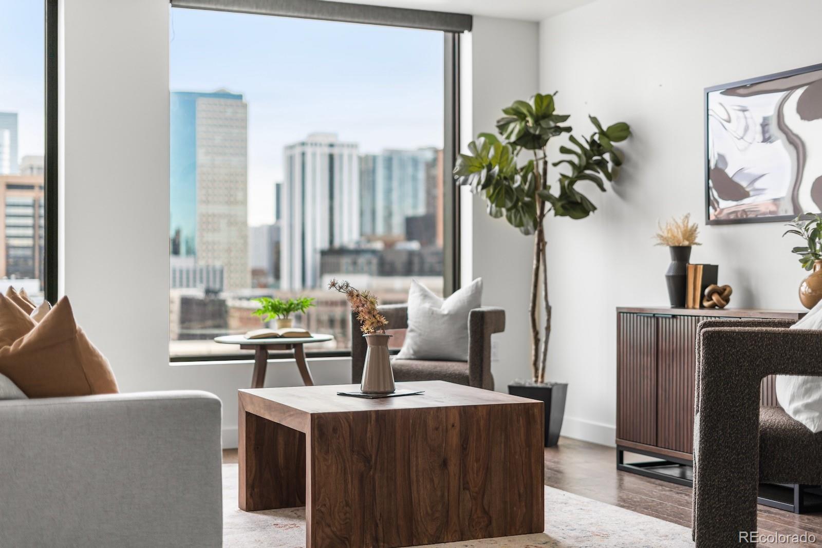 1750 Wewatta Street, Unit 1030 Denver, CO 80202 - Photo 20 of 50 a living room with furniture a chandelier and a potted plant