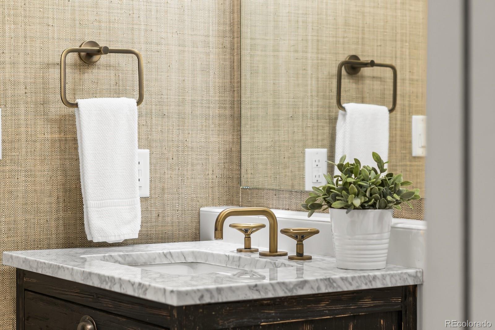 1750 Wewatta Street, Unit 1030 Denver, CO 80202 - Photo 23 of 50 a bathroom with a granite countertop sink and a mirror