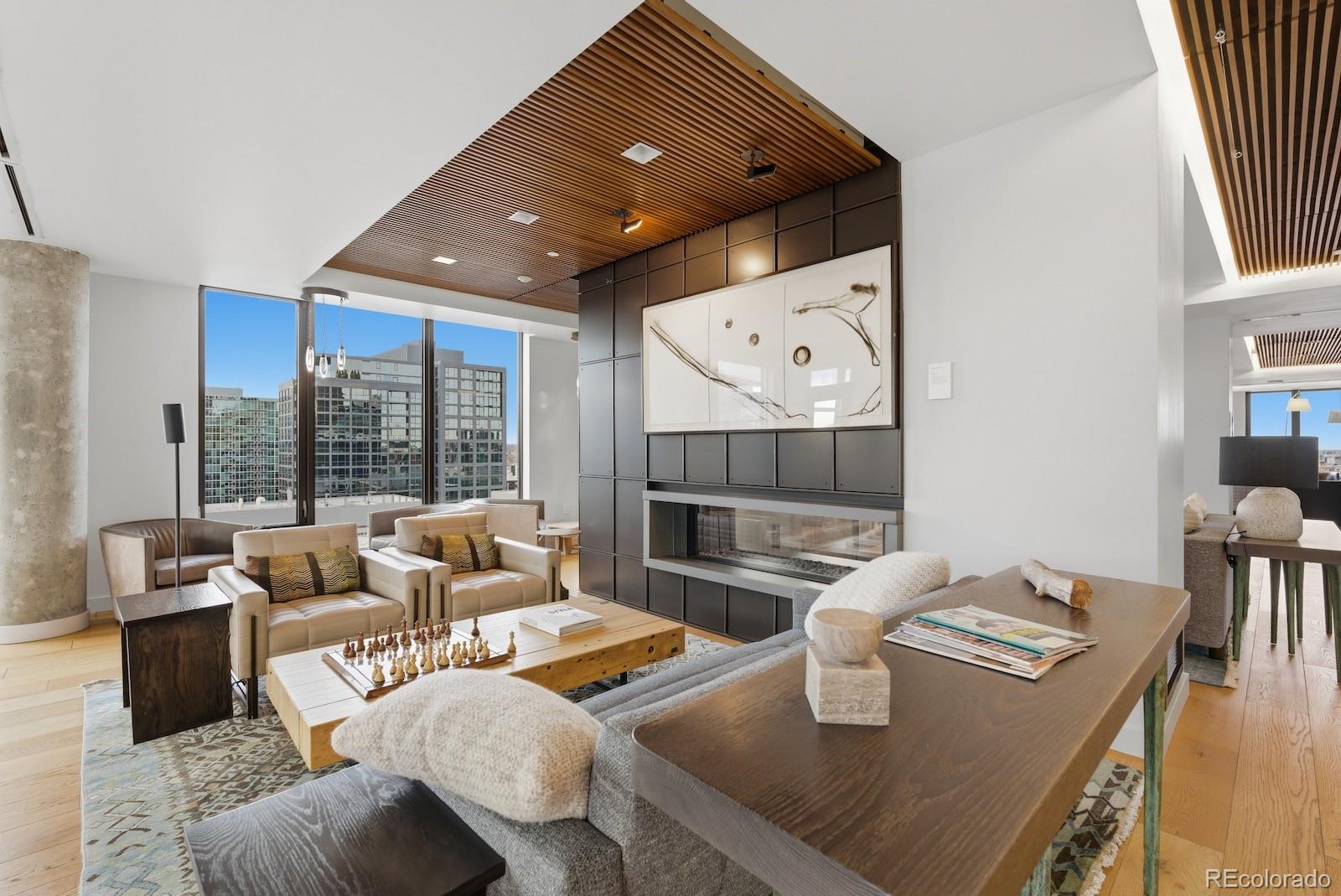 1750 Wewatta Street, Unit 1030 Denver, CO 80202 - Photo 27 of 50 a living room with fireplace furniture and a large window