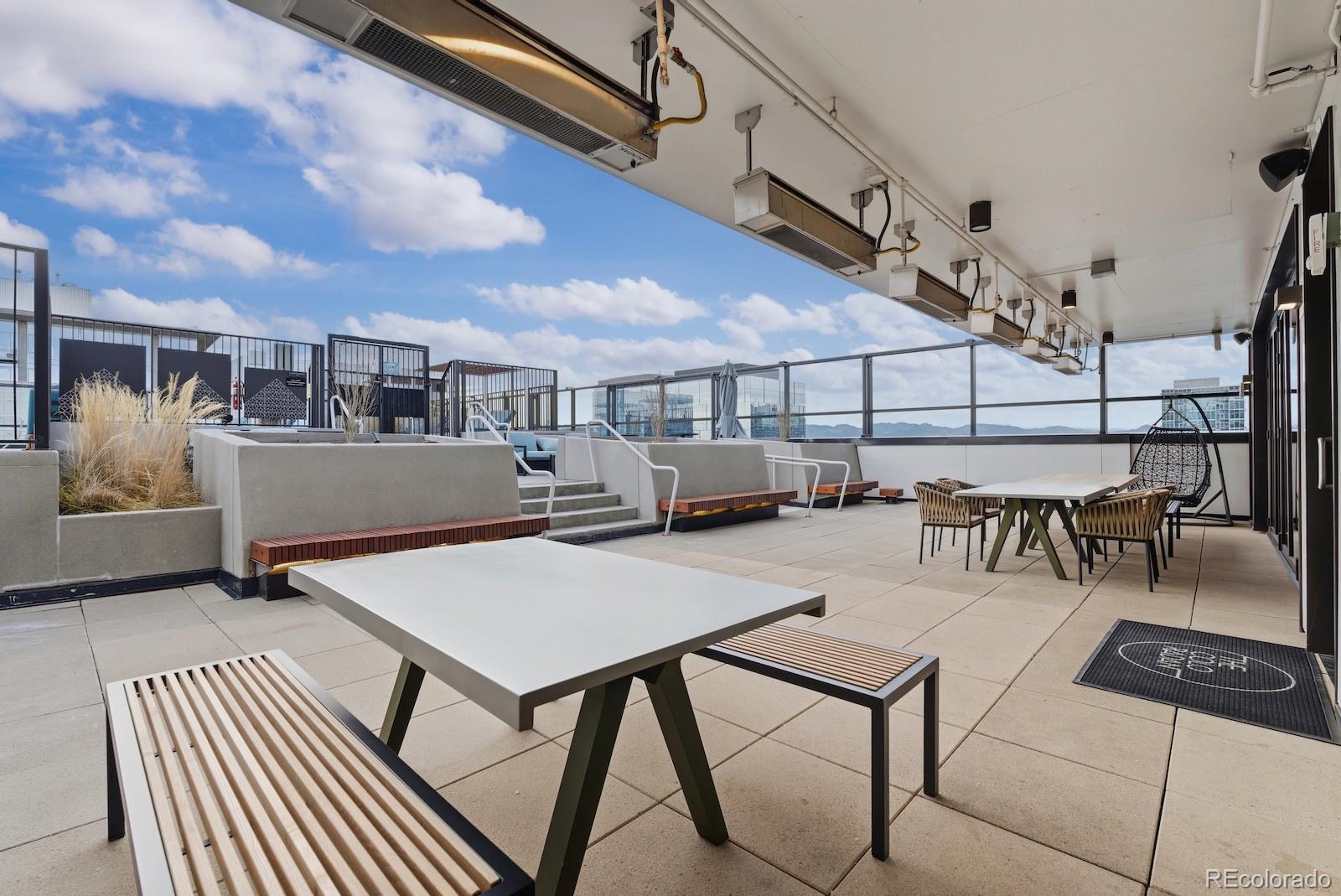 1750 Wewatta Street, Unit 1030 Denver, CO 80202 - Photo 33 of 50 a view of a patio with table and chairs