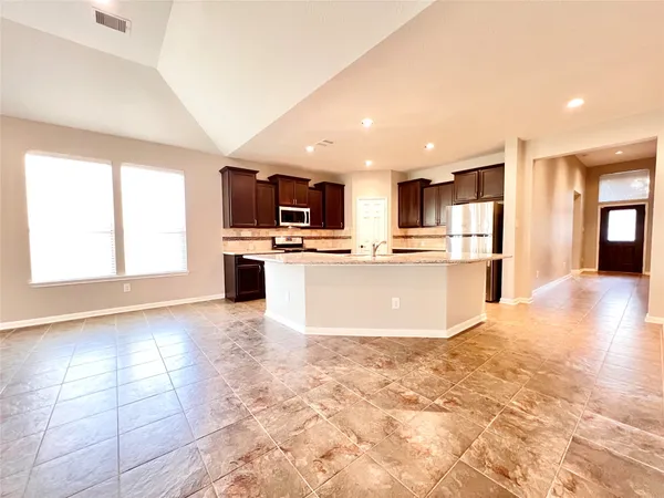 an empty room with window and a ceiling fan