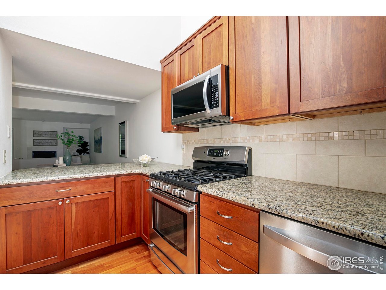 3054 Edison Court Boulder, CO 80301 - Photo 11 of 36 a kitchen with stainless steel appliances granite countertop a stove a sink and a microwave
